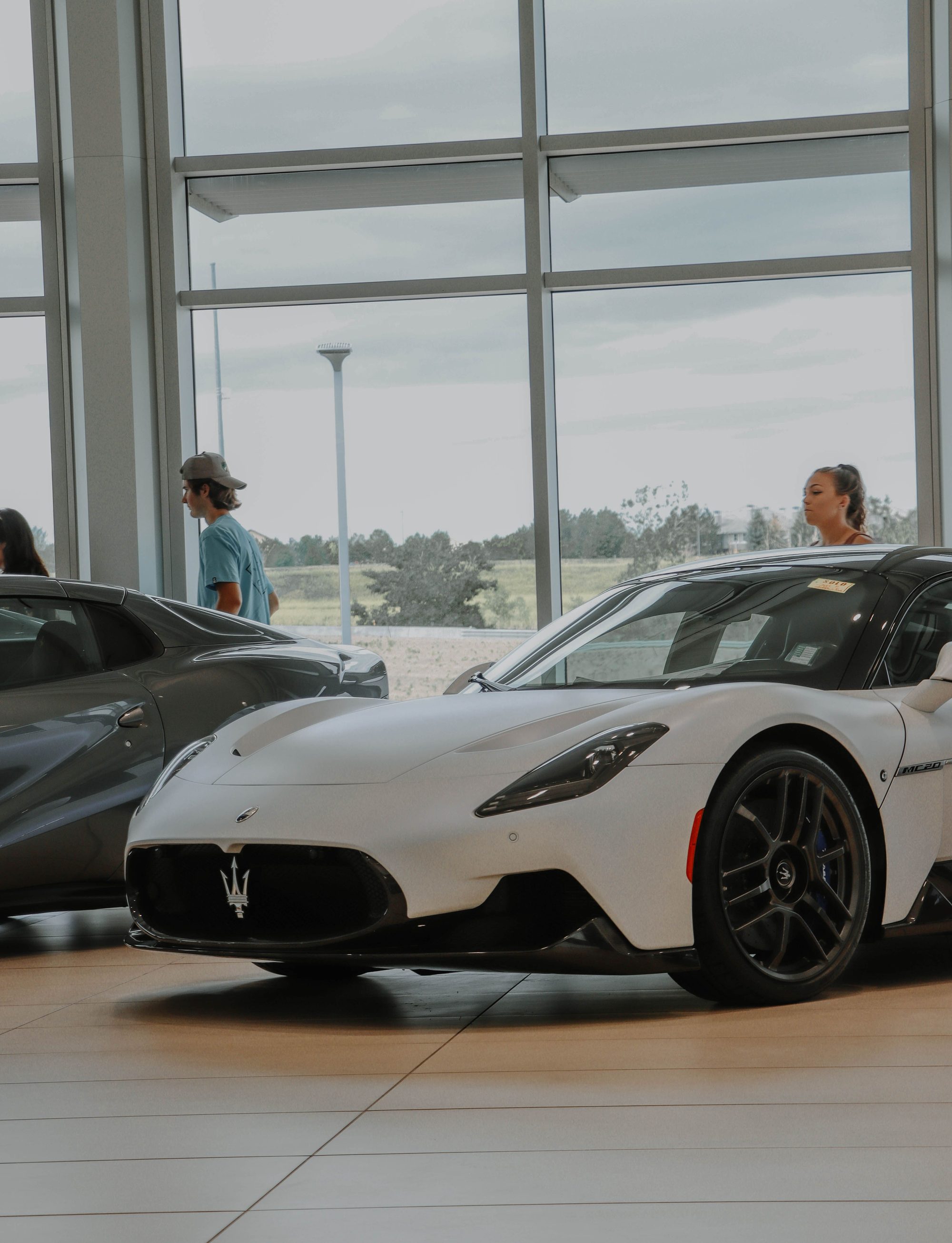A sedan on display inside a bright dealership showroom.